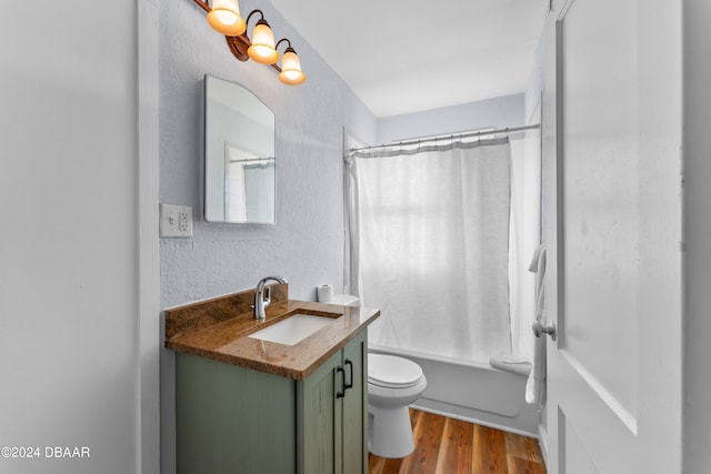 full bathroom with hardwood / wood-style flooring, vanity, toilet, and shower / bath combo with shower curtain