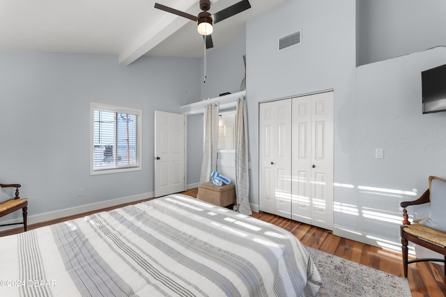 bedroom featuring hardwood / wood-style flooring, high vaulted ceiling, ceiling fan, beam ceiling, and a closet