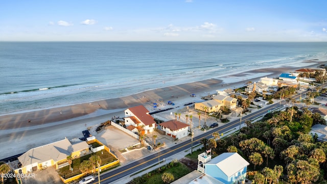 birds eye view of property with a beach view and a water view