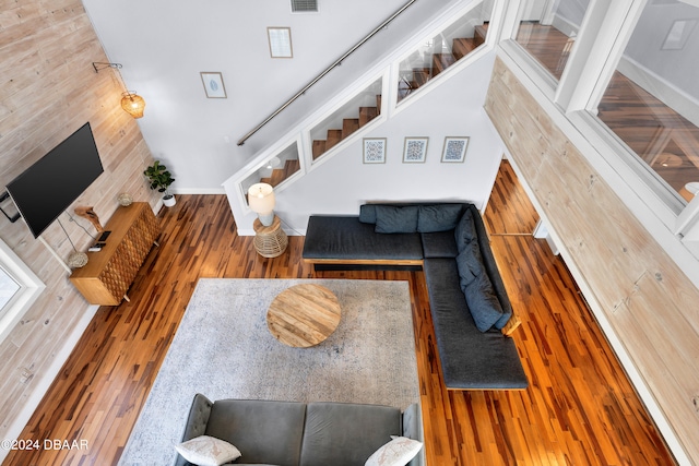 living room with wood walls and hardwood / wood-style flooring