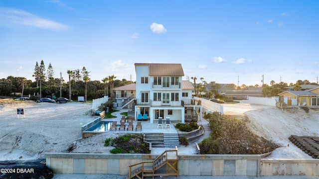 back of house with a patio and a balcony