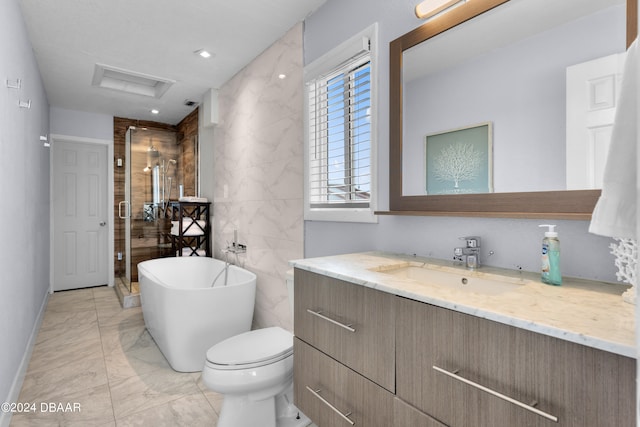 full bathroom featuring vanity, toilet, and separate shower and tub