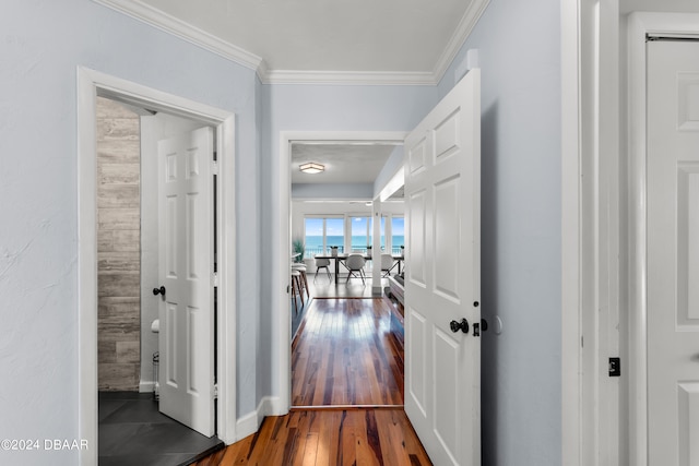 corridor featuring dark hardwood / wood-style floors and crown molding