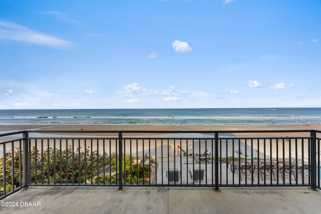 balcony featuring a water view and a view of the beach