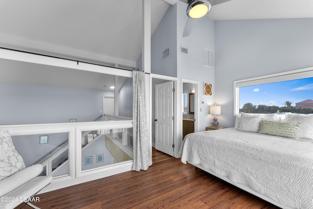 bedroom featuring dark hardwood / wood-style flooring, vaulted ceiling, and ceiling fan