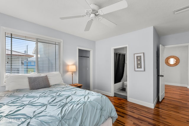 bedroom with ensuite bathroom, dark hardwood / wood-style flooring, a textured ceiling, and ceiling fan