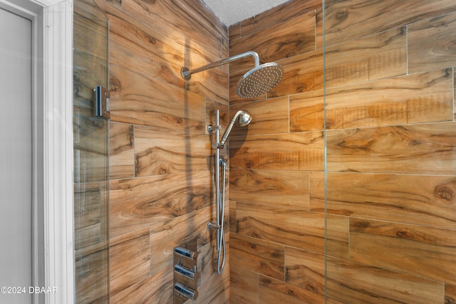 details featuring walk in shower and a textured ceiling