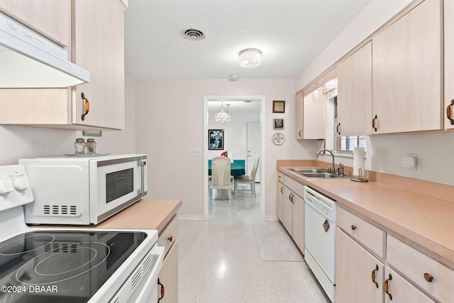 kitchen with white appliances, exhaust hood, sink, light brown cabinets, and pendant lighting