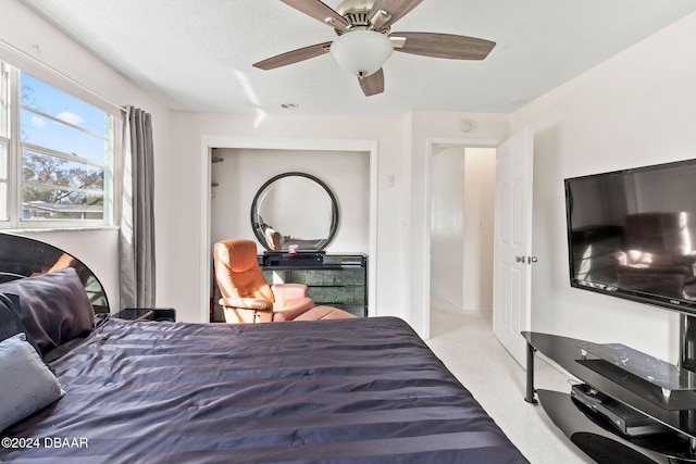 bedroom with ceiling fan and light carpet