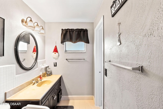 bathroom with tasteful backsplash and vanity