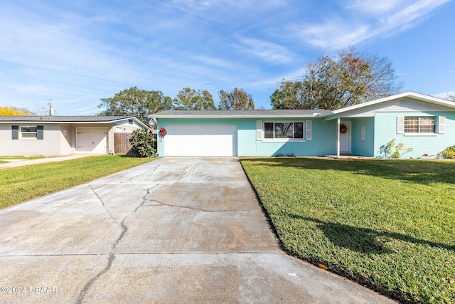 ranch-style house with a garage and a front lawn