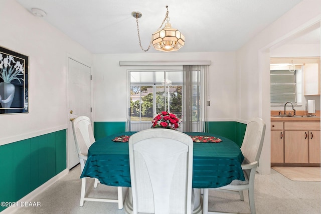 dining space featuring an inviting chandelier and sink