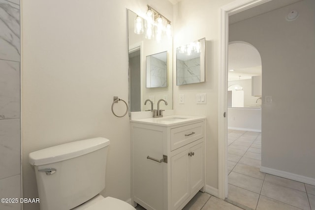 bathroom featuring tile patterned floors, vanity, and toilet