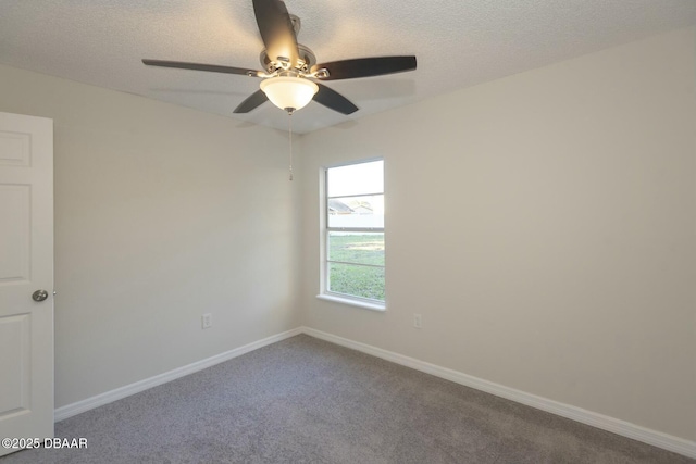 carpeted spare room featuring a textured ceiling and ceiling fan