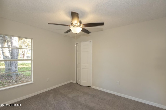 carpeted spare room featuring a textured ceiling