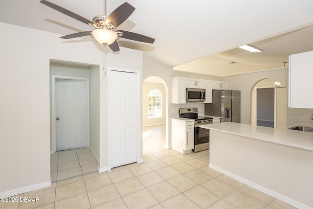 kitchen featuring ceiling fan, white cabinets, light tile patterned floors, and appliances with stainless steel finishes