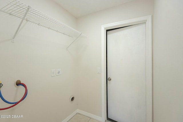 washroom featuring hookup for an electric dryer and light tile patterned floors