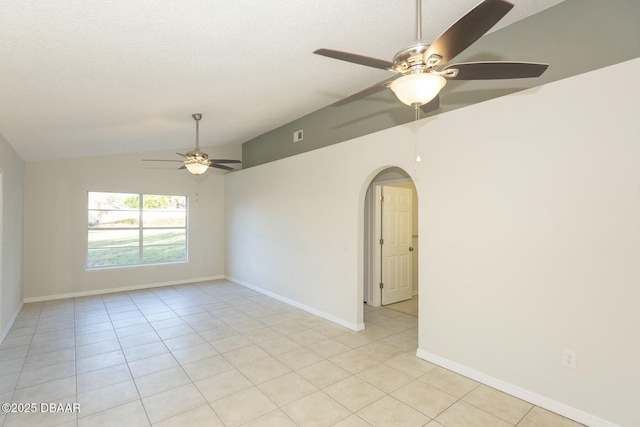 unfurnished room featuring vaulted ceiling, ceiling fan, and light tile patterned flooring