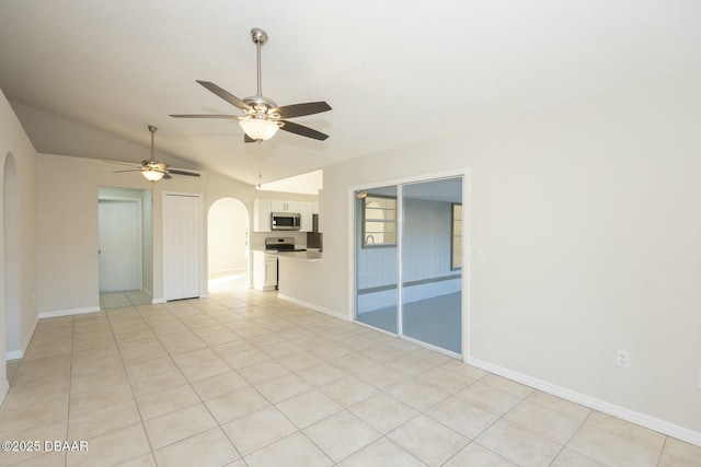 unfurnished room featuring ceiling fan, lofted ceiling, and light tile patterned floors