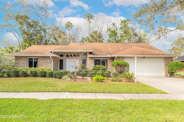 single story home with driveway, a garage, a shingled roof, a front lawn, and brick siding