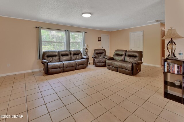 living room with light tile patterned flooring, baseboards, crown molding, and a textured ceiling