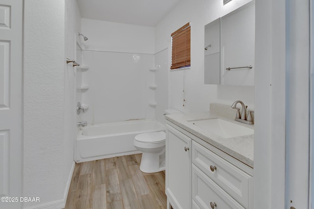 bathroom featuring toilet, vanity, bathtub / shower combination, and wood finished floors