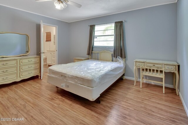 bedroom featuring light wood-type flooring, ornamental molding, baseboards, connected bathroom, and a ceiling fan