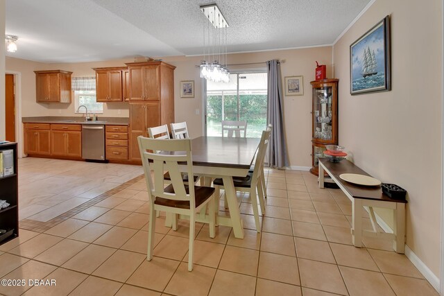 dining room featuring a textured ceiling, a wealth of natural light, baseboards, and light tile patterned floors