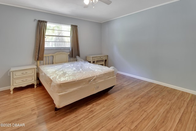 bedroom featuring light wood-style flooring, ornamental molding, and baseboards