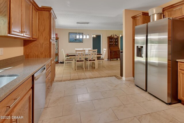 kitchen with stainless steel fridge, visible vents, dishwasher, light stone countertops, and brown cabinets