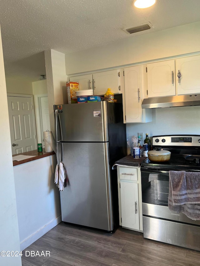 kitchen with dark hardwood / wood-style flooring, white cabinetry, a textured ceiling, and appliances with stainless steel finishes