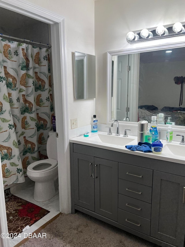 bathroom with walk in shower, vanity, and toilet