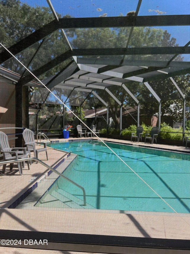 view of pool featuring a lanai and a patio area