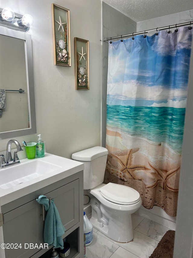 bathroom with toilet, vanity, and a textured ceiling