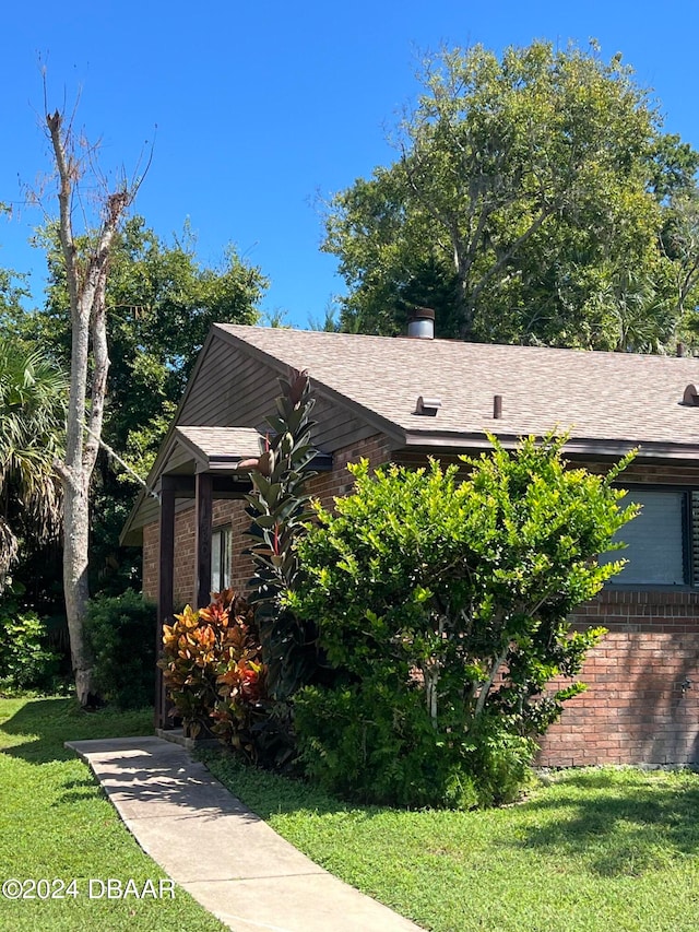 view of home's exterior with a yard