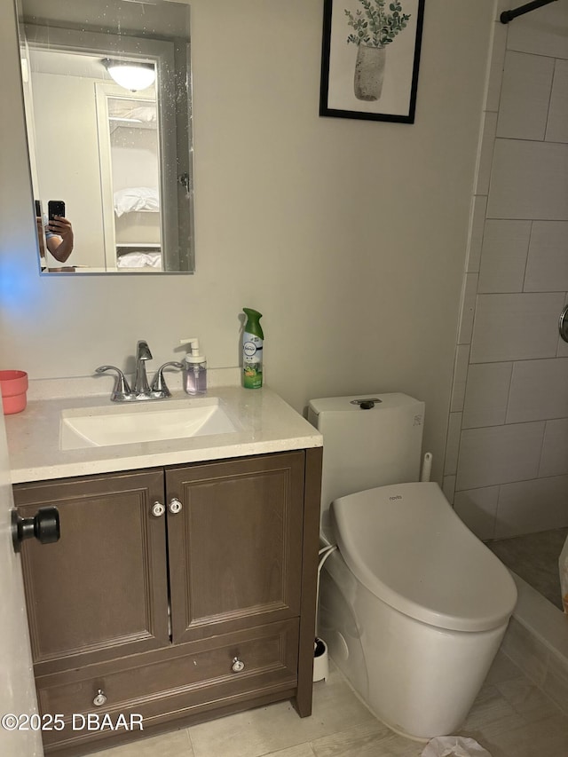 bathroom featuring vanity, a shower, and toilet