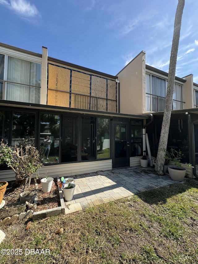 back of house with a patio