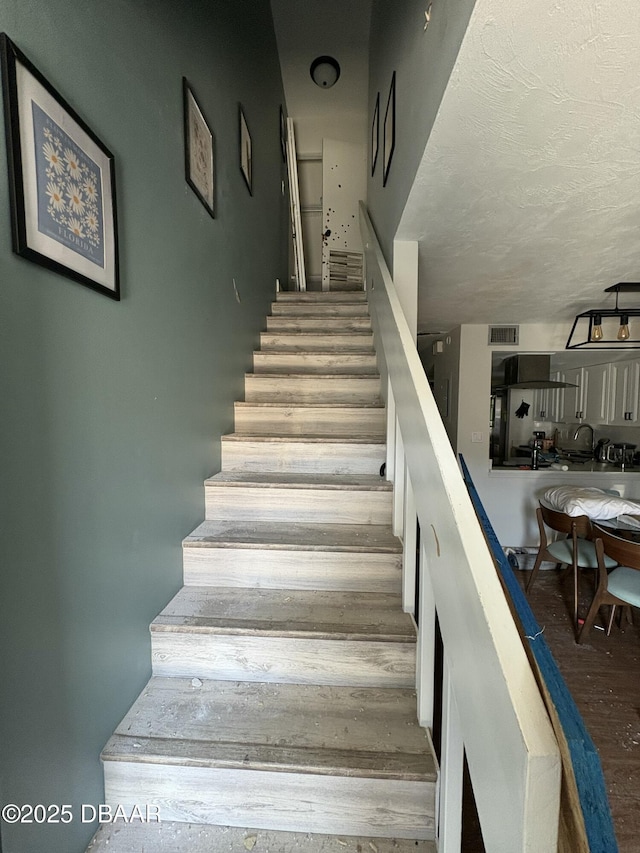 stairway with wood-type flooring