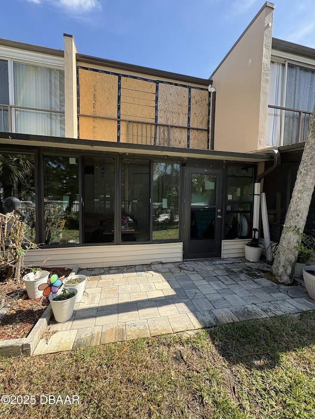 back of property with a patio