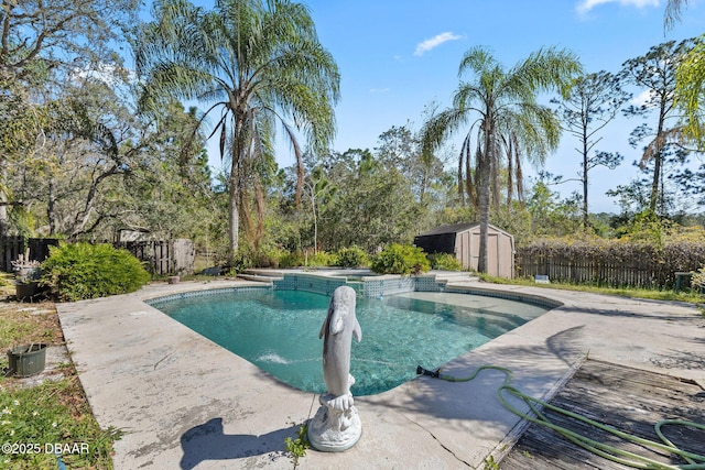 view of pool featuring a pool with connected hot tub, a patio, a fenced backyard, a shed, and an outdoor structure