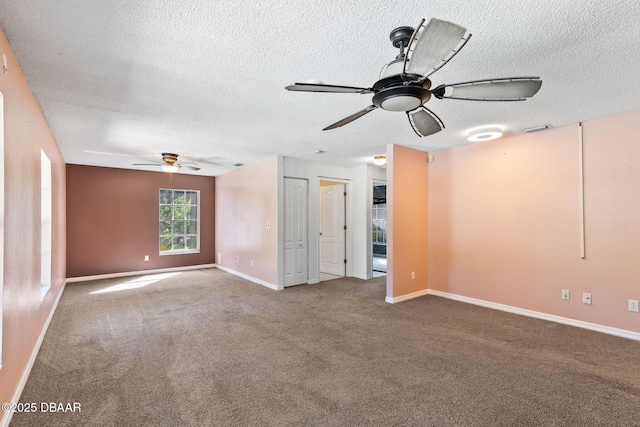 empty room with baseboards, a ceiling fan, carpet flooring, and a textured ceiling