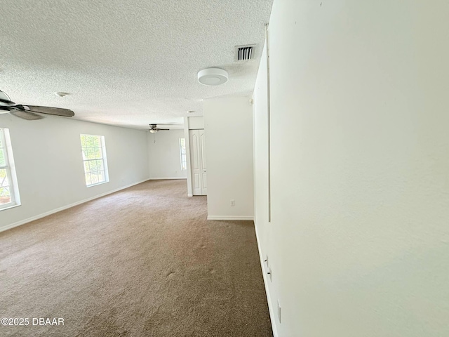 3531 Red Barn Ln, Ormond Beach, FL 32174 - empty room with ceiling fan, baseboards, a textured ceiling, and carpet floors