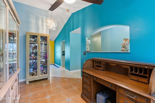 home office featuring lofted ceiling, light tile patterned flooring, baseboards, and a chandelier