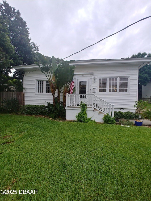 view of front of home featuring a front yard, crawl space, and fence