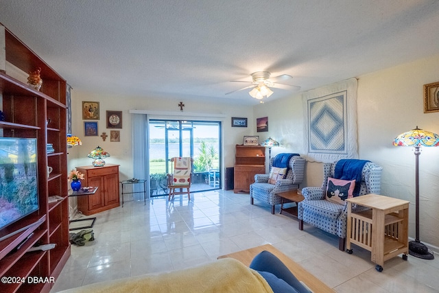 tiled living room with a textured ceiling and ceiling fan