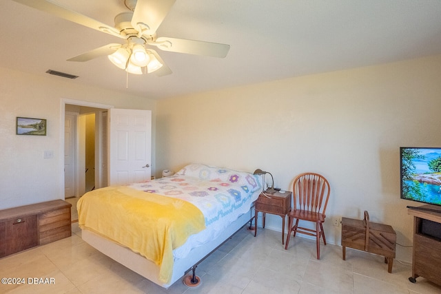 tiled bedroom with ceiling fan