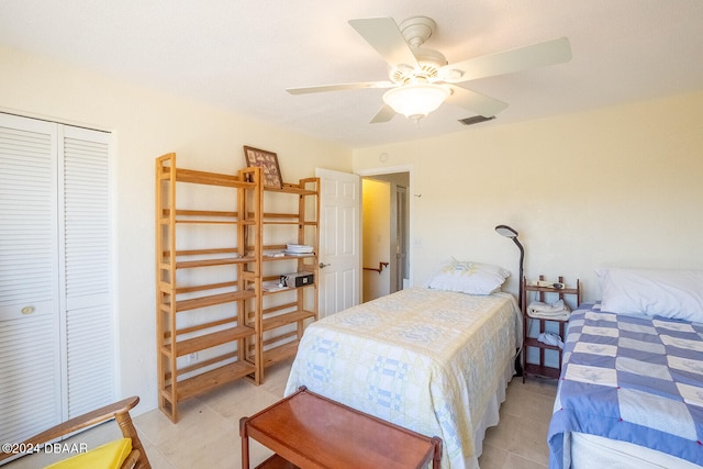 bedroom featuring light tile patterned floors, a closet, and ceiling fan