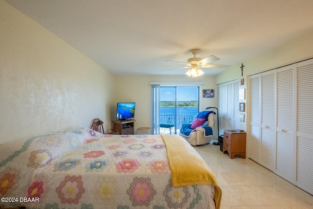 bedroom featuring access to outside, ceiling fan, light tile patterned floors, and two closets