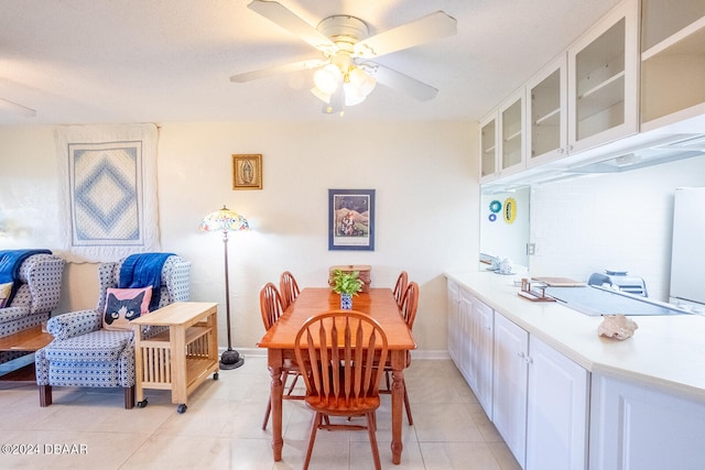 tiled dining room featuring ceiling fan