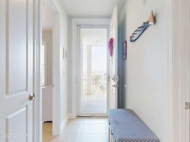 doorway to outside with light tile patterned floors